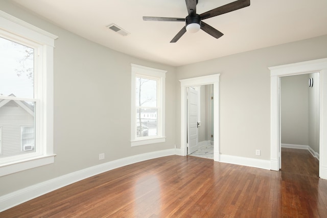 unfurnished bedroom with ceiling fan and dark hardwood / wood-style flooring