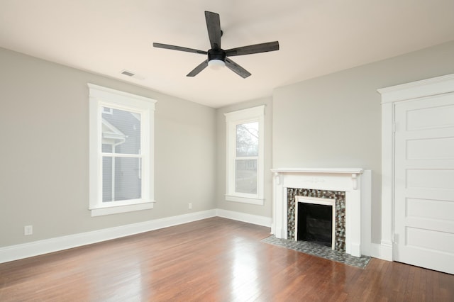 unfurnished living room with ceiling fan and dark hardwood / wood-style flooring