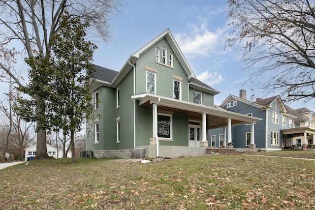 view of front of home featuring a porch, central AC unit, and a front yard