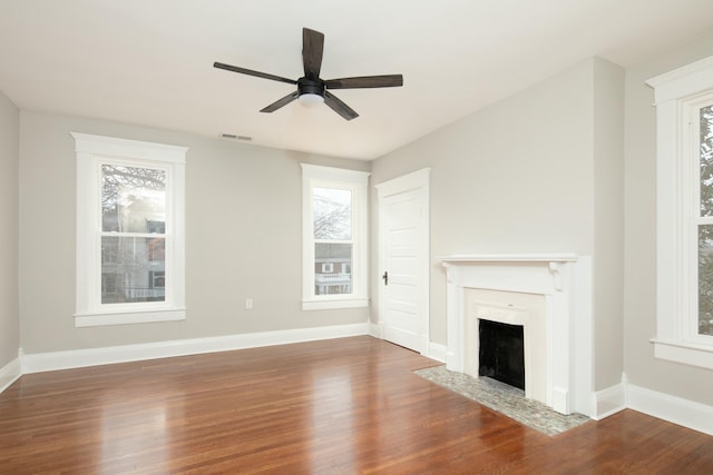 unfurnished living room with ceiling fan and dark wood-type flooring