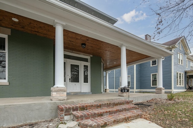 view of exterior entry with a porch