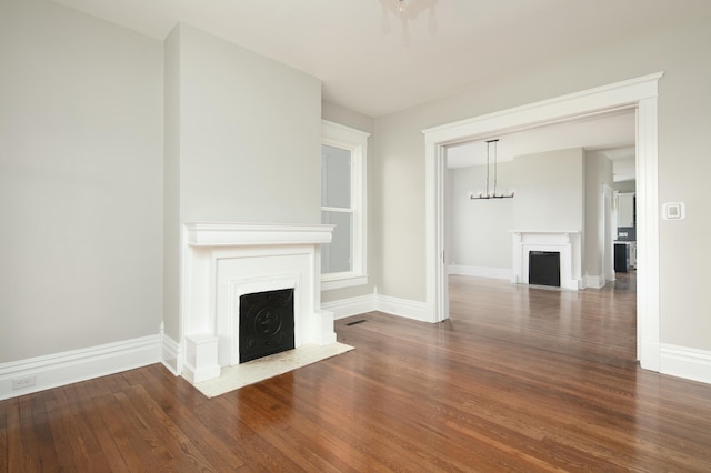 unfurnished living room with dark hardwood / wood-style floors