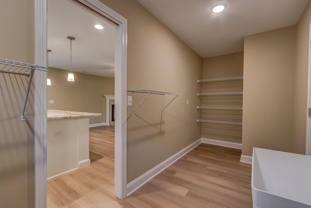 walk in closet featuring light hardwood / wood-style flooring