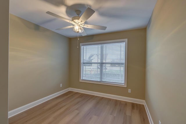 spare room with ceiling fan and light wood-type flooring