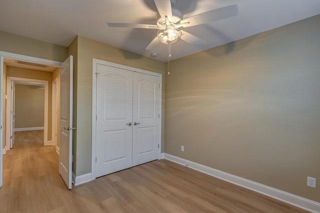 unfurnished bedroom with ceiling fan, a closet, and light hardwood / wood-style floors