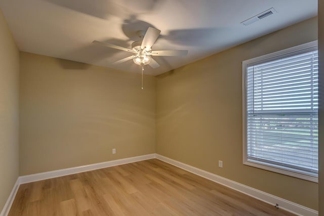 spare room featuring ceiling fan, a healthy amount of sunlight, and light hardwood / wood-style floors