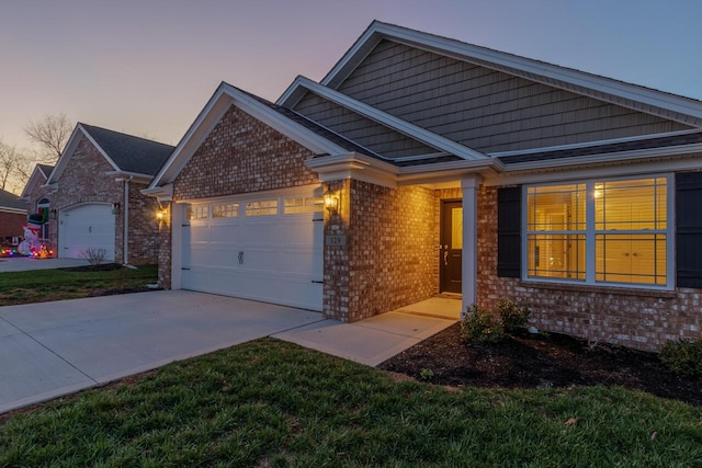 craftsman-style home featuring a lawn and a garage