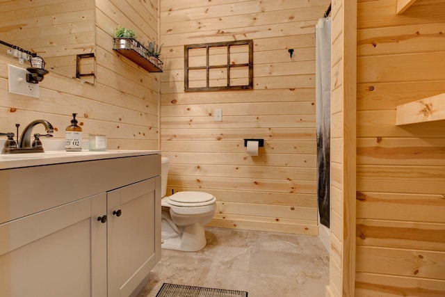 bathroom with walk in shower, wood walls, vanity, and toilet