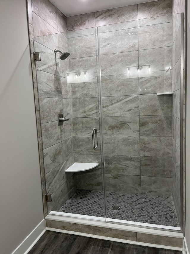 bathroom featuring wood-type flooring and walk in shower