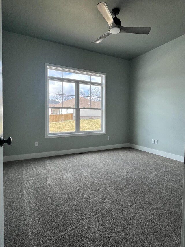 spare room with light carpet and ceiling fan