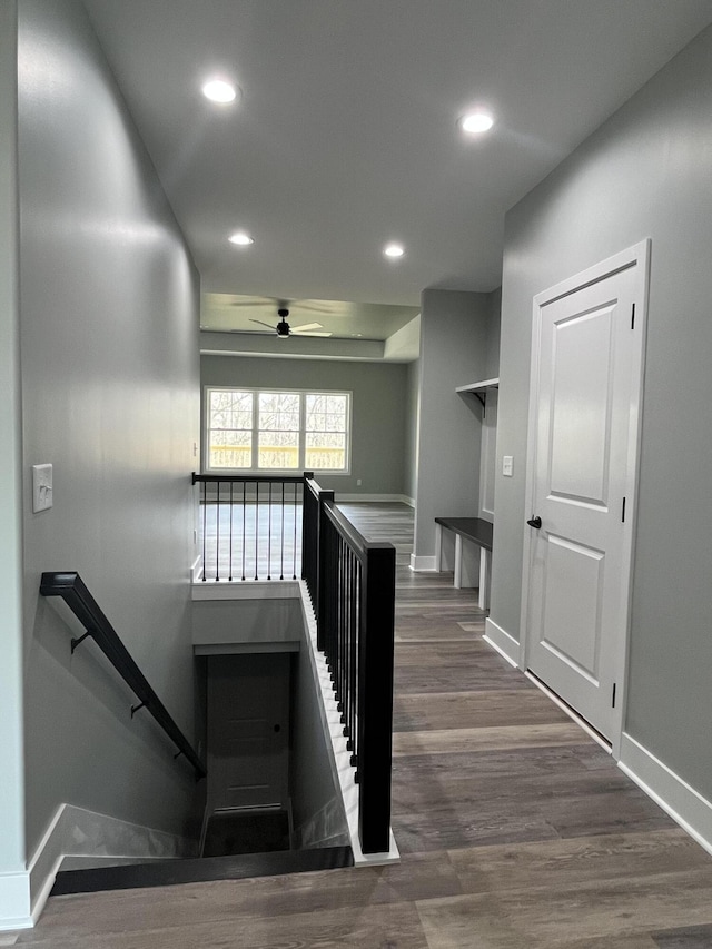 stairs featuring a ceiling fan, baseboards, wood finished floors, and recessed lighting