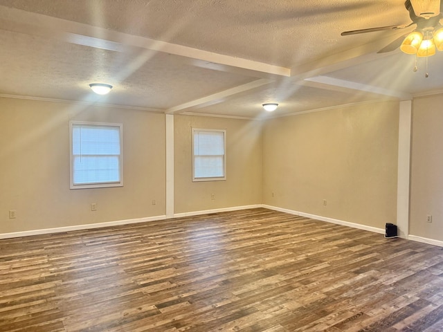 empty room with a textured ceiling, ceiling fan, crown molding, and dark wood-type flooring