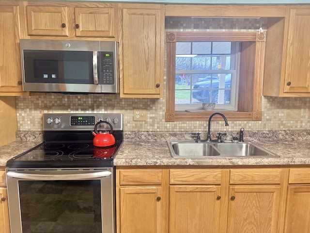 kitchen featuring backsplash, sink, and stainless steel appliances