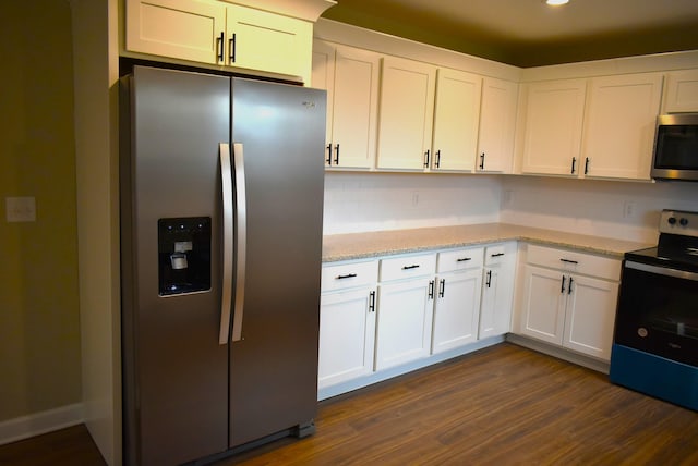 kitchen featuring white cabinetry, tasteful backsplash, light stone counters, dark hardwood / wood-style floors, and appliances with stainless steel finishes