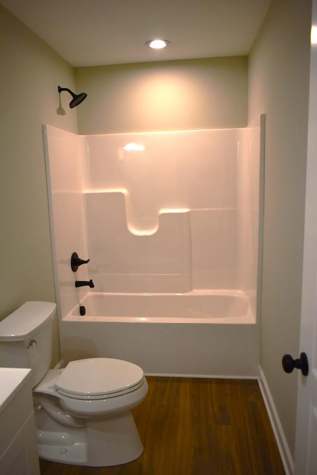 full bathroom featuring hardwood / wood-style floors, vanity, toilet, and shower / bathtub combination