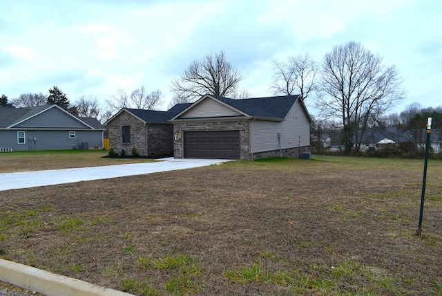 single story home with a garage and a front lawn