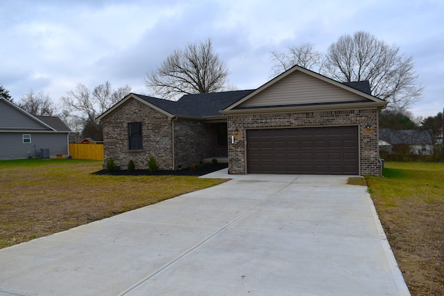 ranch-style house featuring a garage, a front yard, and central AC