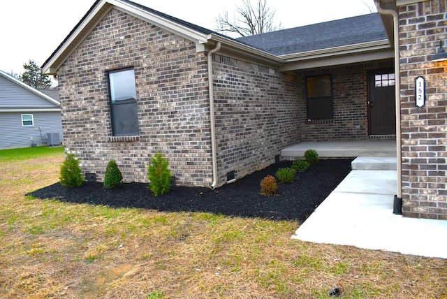 view of property exterior with central AC unit and a lawn