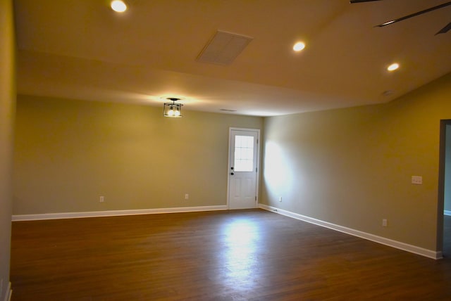 spare room with ceiling fan, dark hardwood / wood-style flooring, and vaulted ceiling