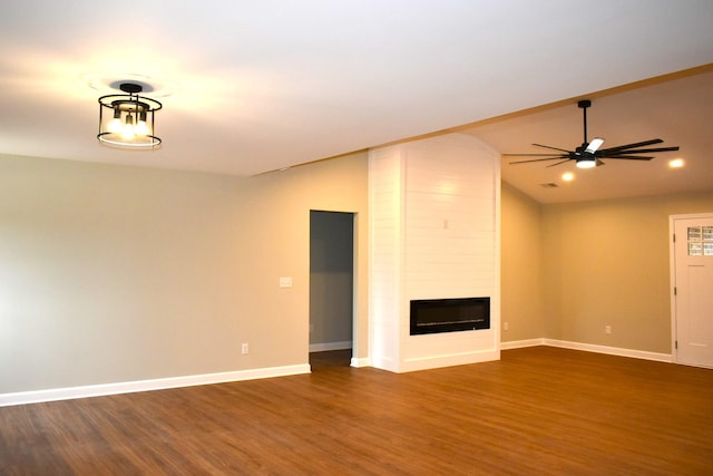 unfurnished living room featuring a fireplace, ceiling fan, lofted ceiling, and dark wood-type flooring