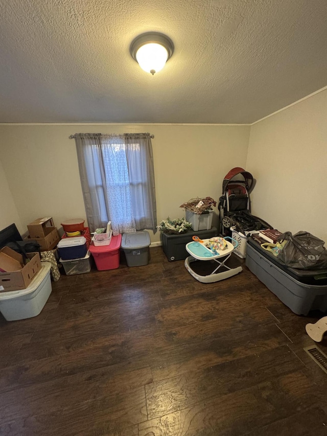 miscellaneous room featuring a textured ceiling and dark hardwood / wood-style flooring