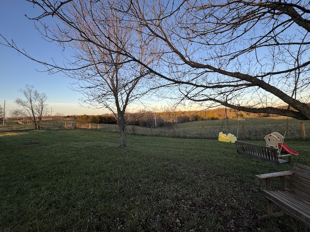 yard at dusk with a rural view