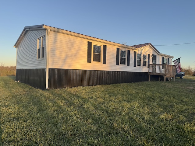 view of property exterior featuring a deck and a lawn