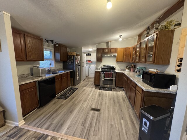 laundry area featuring cabinets, a textured ceiling, dark hardwood / wood-style flooring, and washer and dryer