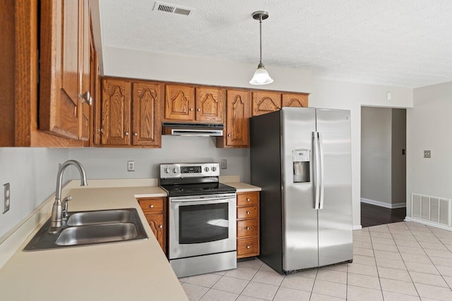 kitchen with a sink, stainless steel appliances, extractor fan, and visible vents