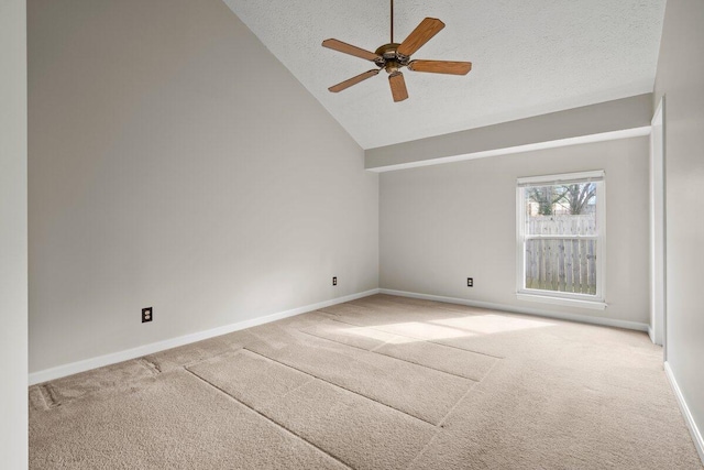 unfurnished room featuring lofted ceiling, a textured ceiling, carpet flooring, baseboards, and ceiling fan