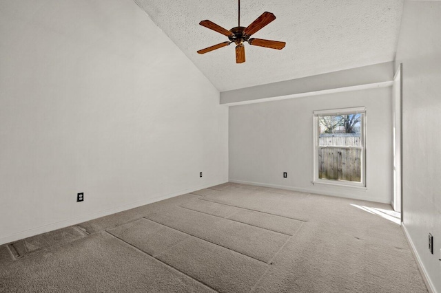 interior space with ceiling fan, lofted ceiling, carpet flooring, and a textured ceiling