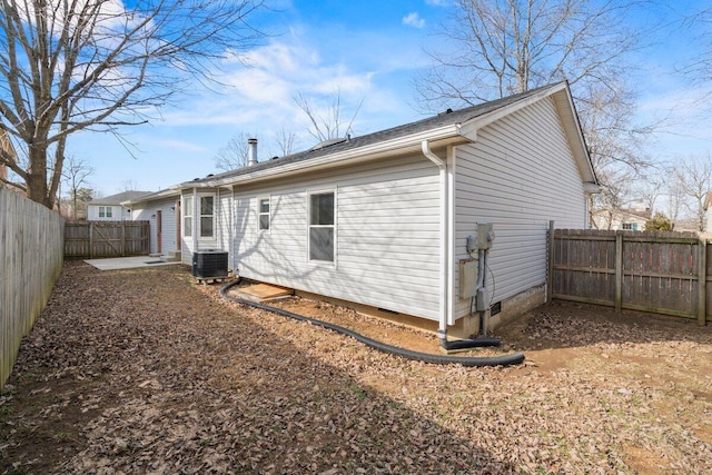 back of property featuring cooling unit and a fenced backyard