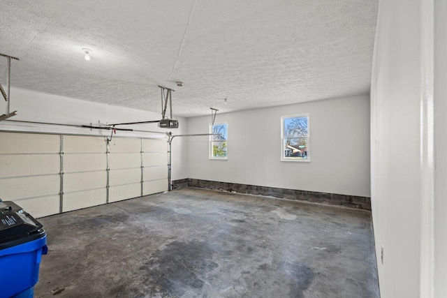 garage with baseboards and a garage door opener