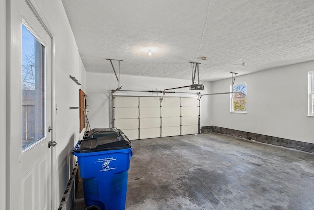 garage featuring a garage door opener and baseboards