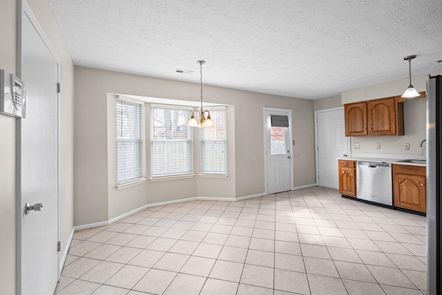 kitchen with visible vents, light countertops, dishwasher, decorative light fixtures, and brown cabinets