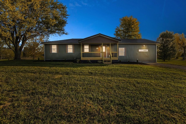 ranch-style home with covered porch and a front yard