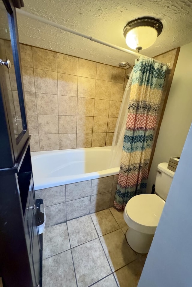 bathroom with tile patterned flooring, a textured ceiling, toilet, and shower / bath combo with shower curtain