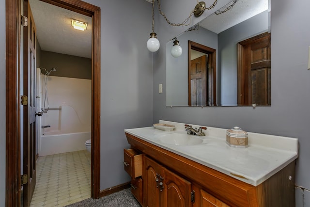 full bathroom featuring vanity, shower / bathtub combination, toilet, and a textured ceiling