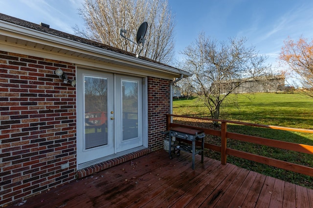 wooden deck featuring a lawn and french doors