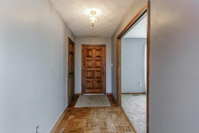 doorway to outside featuring light parquet flooring