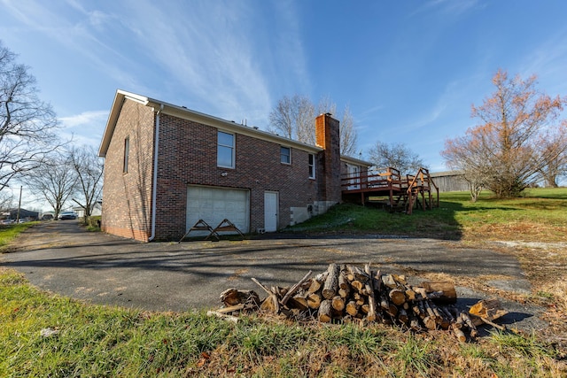 back of house featuring a wooden deck and a garage