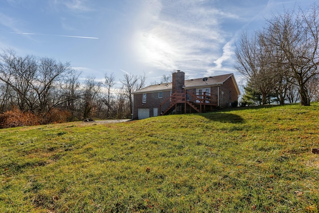 view of yard with a garage and a wooden deck