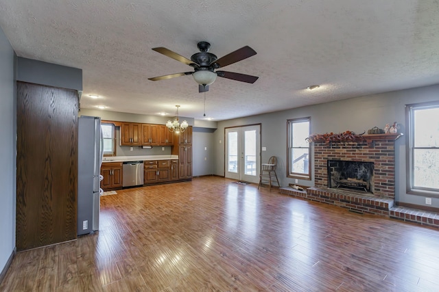 unfurnished living room featuring hardwood / wood-style flooring, a textured ceiling, and french doors