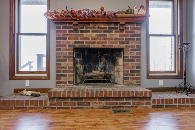 interior details with hardwood / wood-style flooring and a fireplace