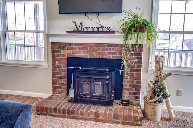 interior details with a wood stove and carpet floors