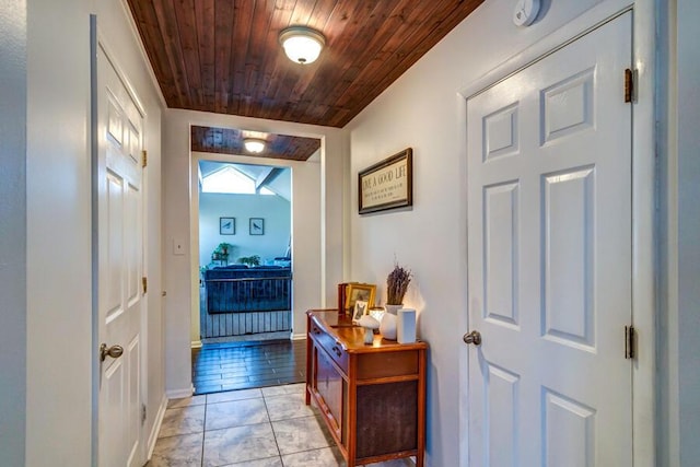 doorway featuring wooden ceiling and light tile patterned floors