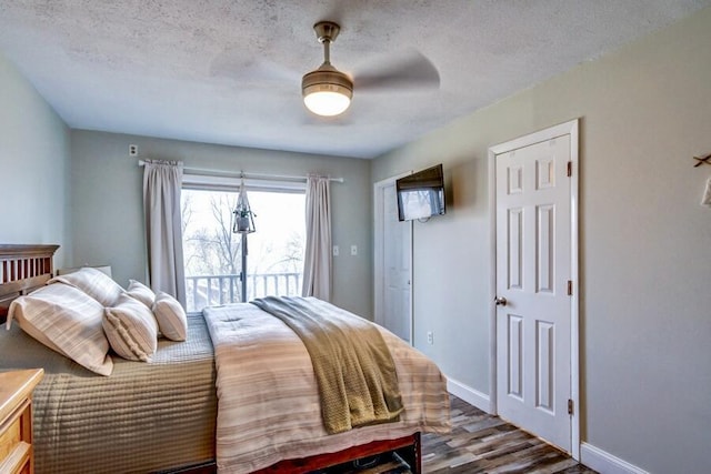 bedroom with ceiling fan, access to outside, a textured ceiling, and hardwood / wood-style flooring