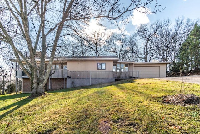 view of front of house with a garage and a front lawn