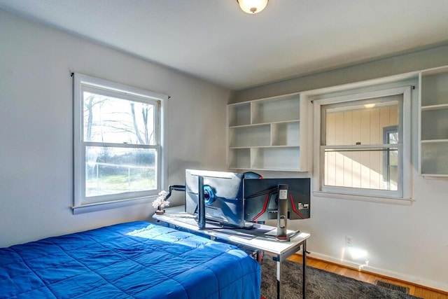 bedroom with hardwood / wood-style flooring