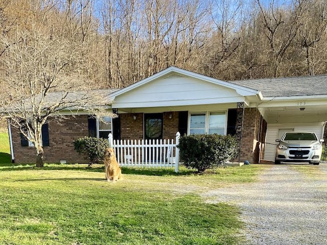 ranch-style home with a front yard and a carport